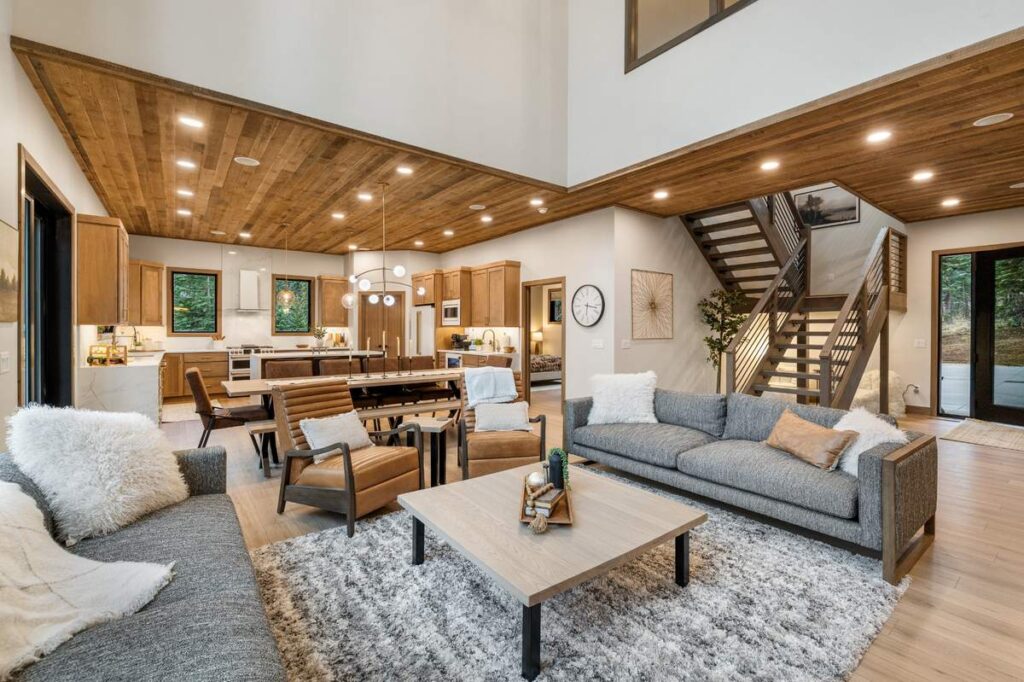 Cozy living room with wood ceiling, kitchenette, and modern furniture layout