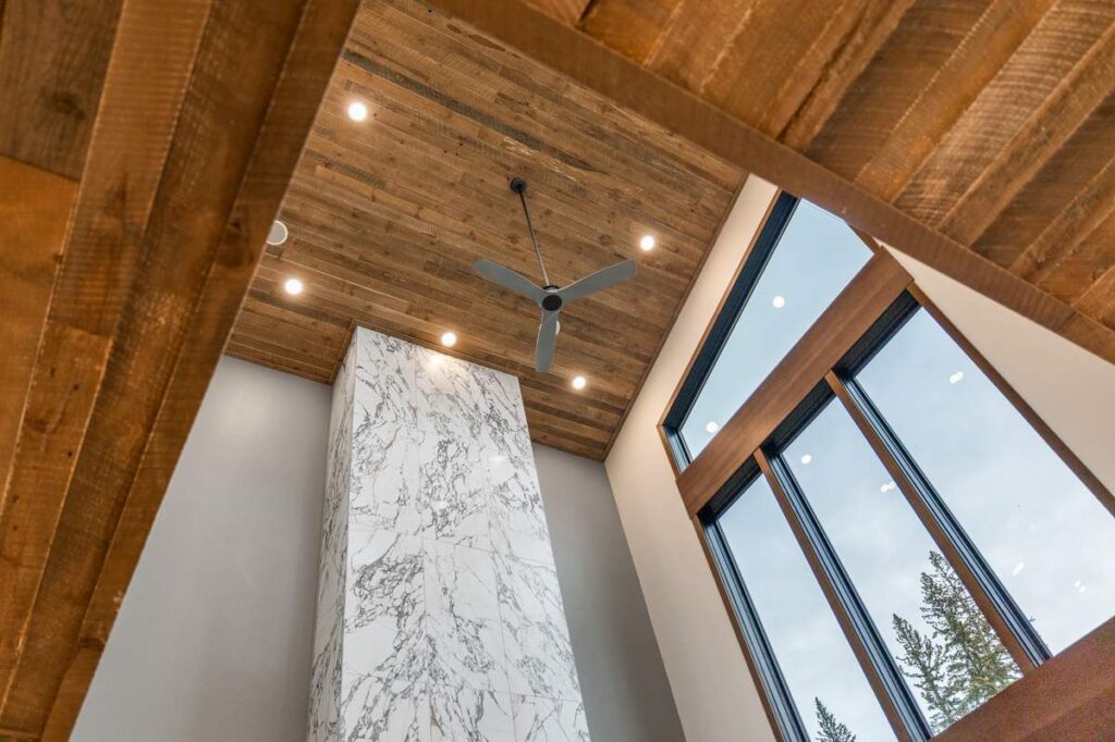 Open loft living space with wood floors, railing, and dining area